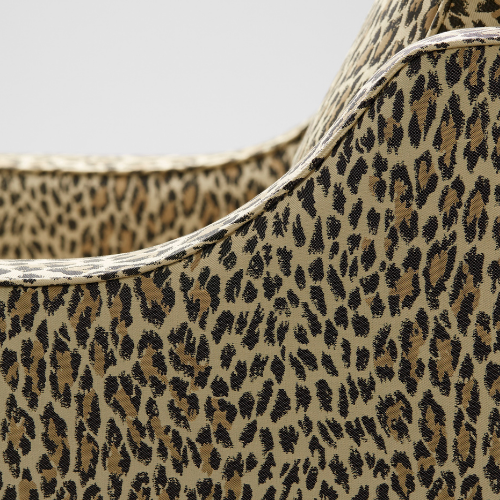 Close up of The Reposer Chair, showing the legs and detailing with leopard print fabric