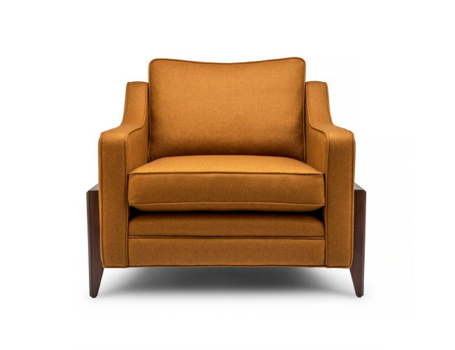 A mustard-colored armchair with wooden legs against a white background.
