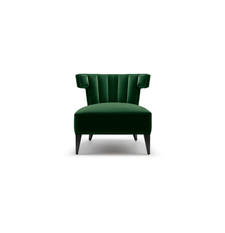 Green upholstered armchair with a high backrest and tapered black legs on a white background.