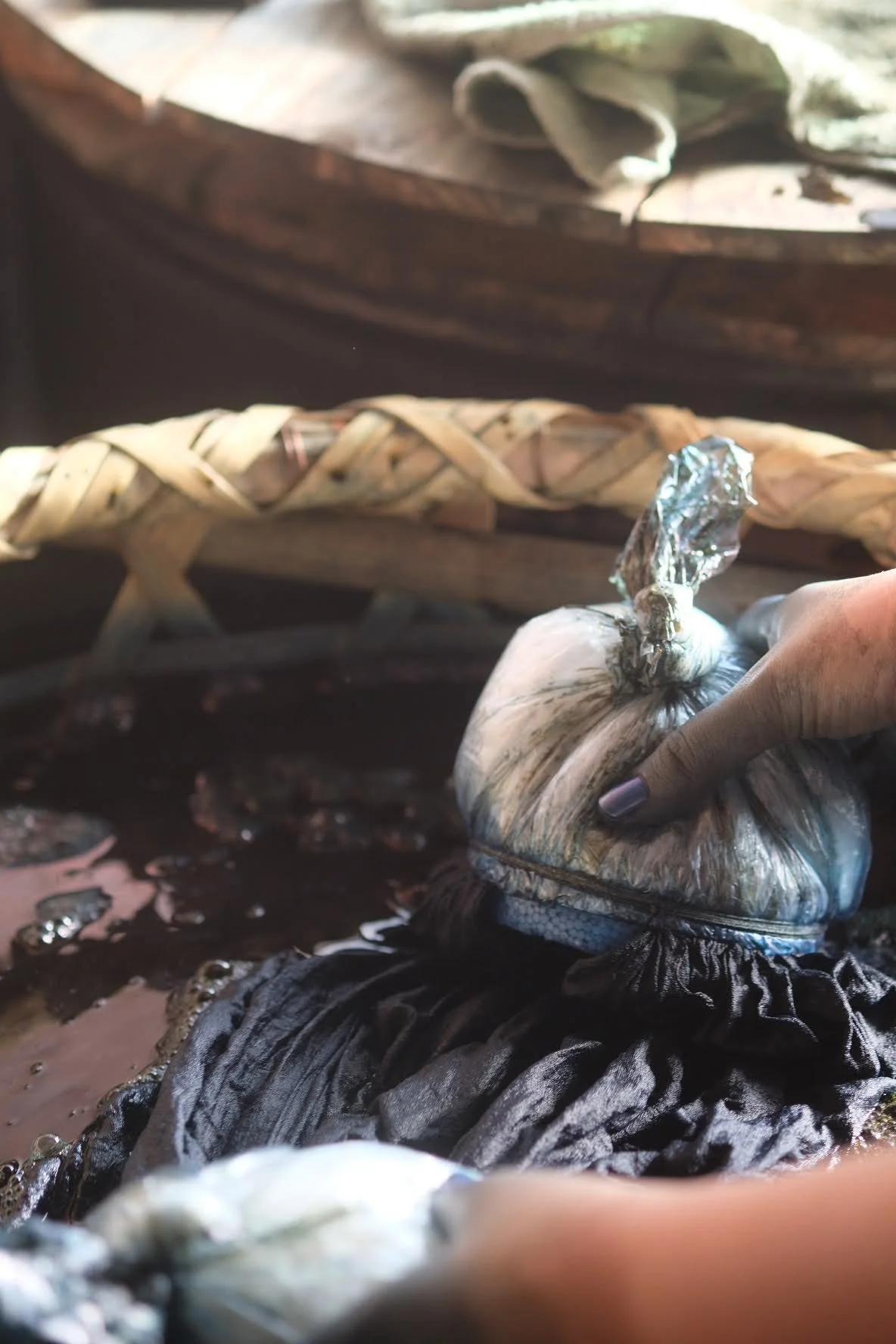 Hands in an indigo dye vat