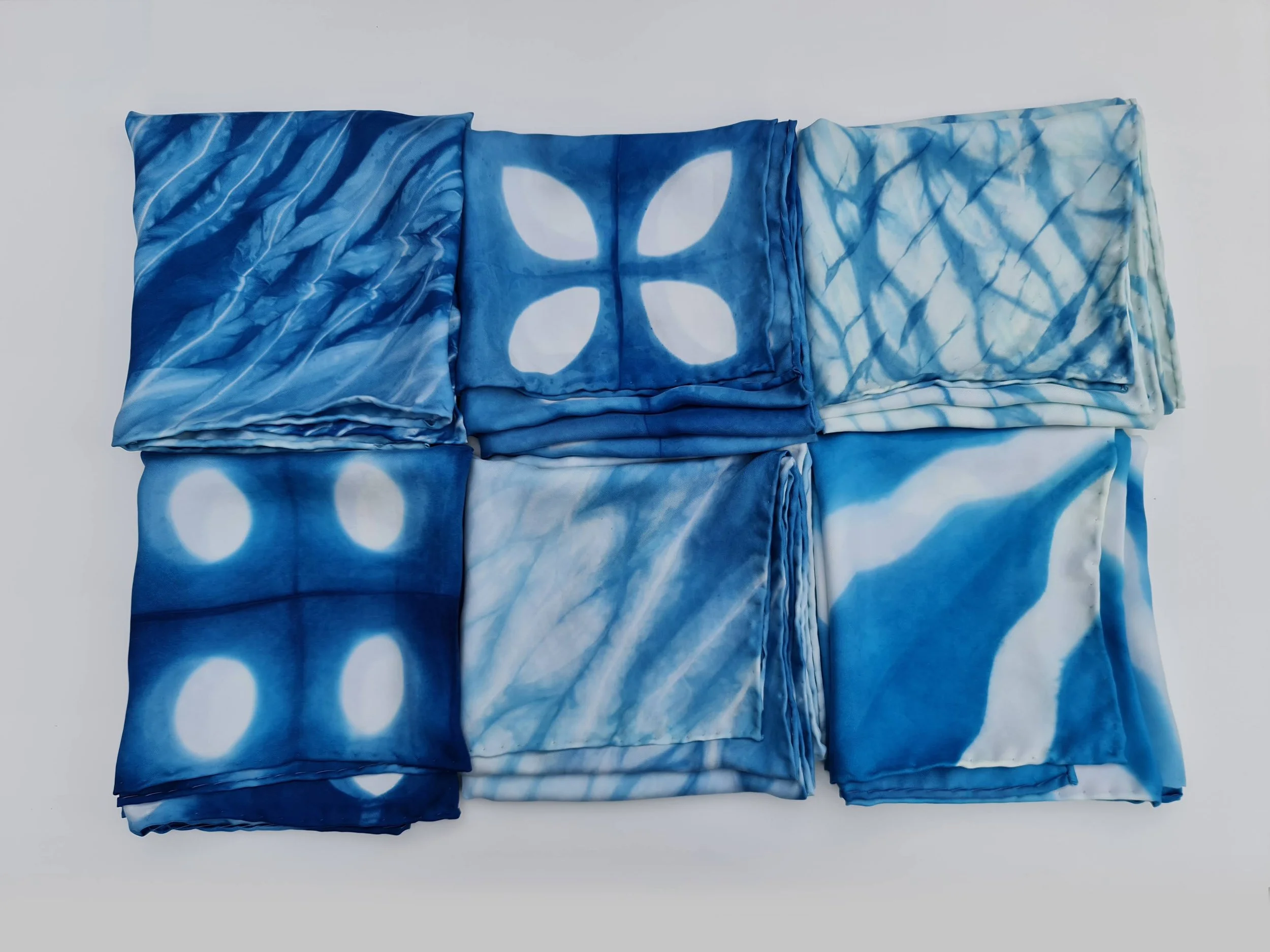 Six indigo shibori scarves folded.jpg