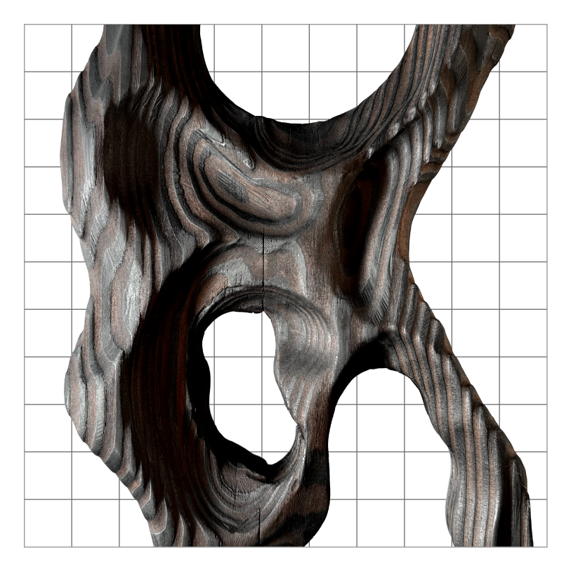 Close-up of a carved wooden sculpture featuring a face with hollow openings, showcasing textured and layered wood grain patterns.