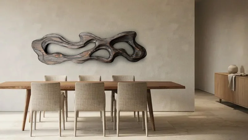 A modern dining room with a wooden table, six beige chairs, and an abstract wall art piece.