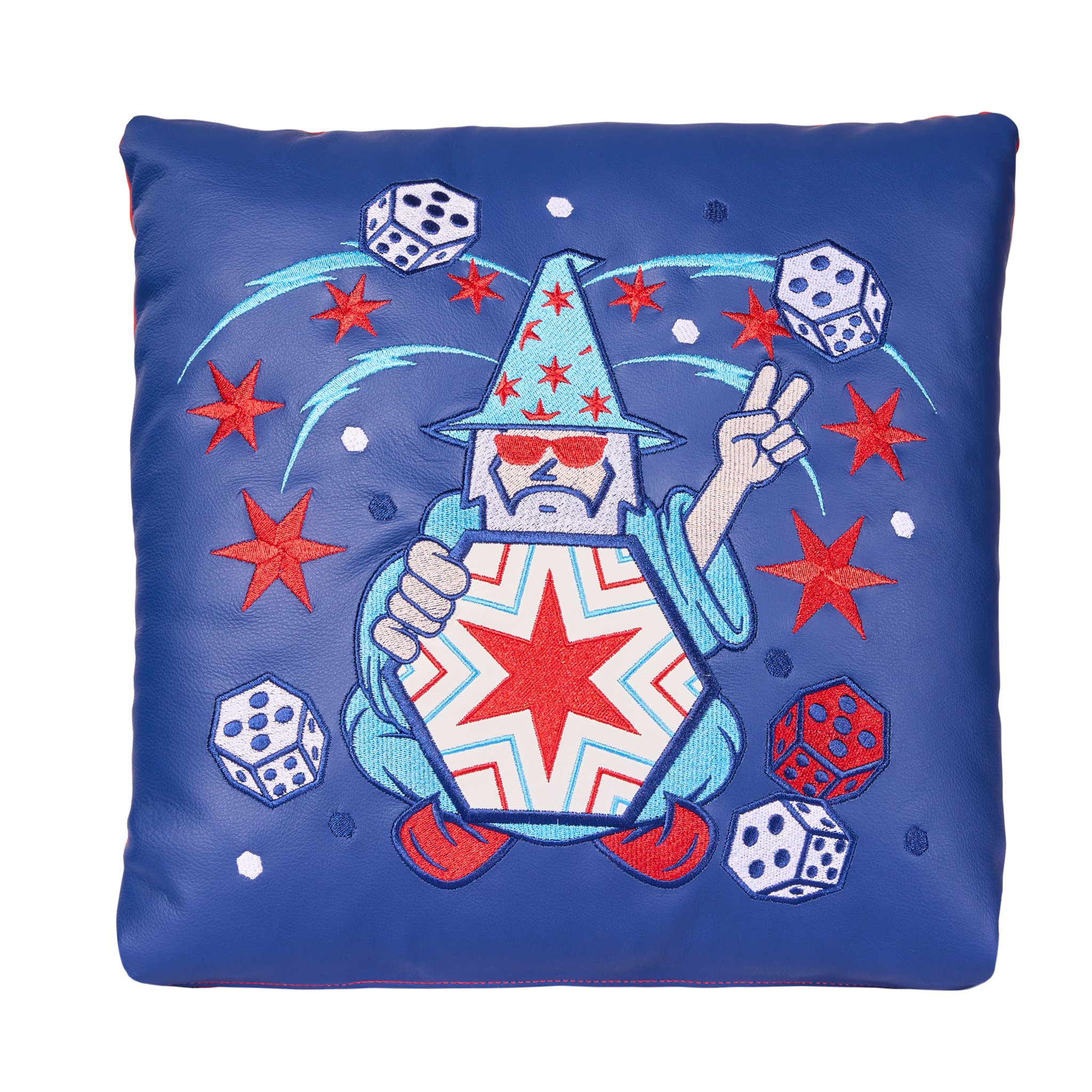 A blue fabric with patriotic embroidery featuring a witch's hat, stars, dice, and a peace sign.