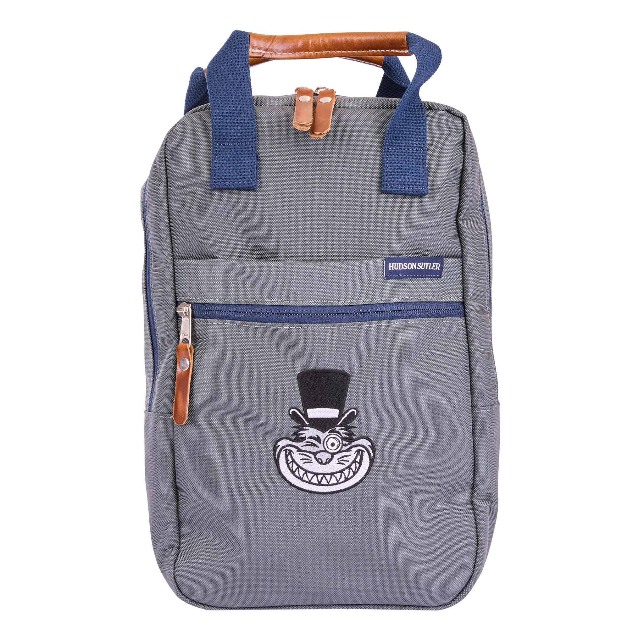 A gray backpack with blue straps, brown accents, a front zip pocket, a leather top handle, and a printed design of a grinning cartoon face on the front.