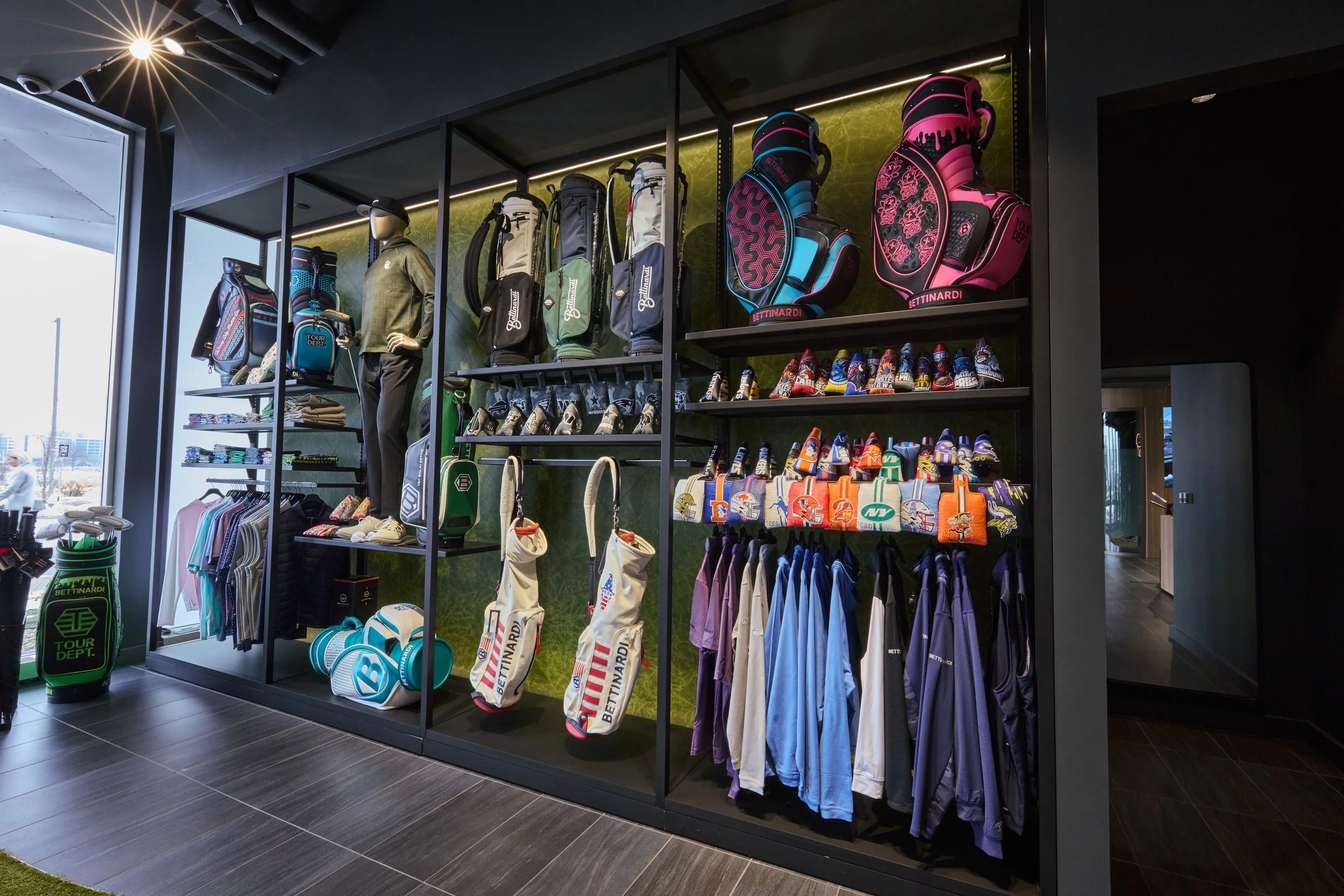 Golf shop display with golf bags, shoes, and clothing