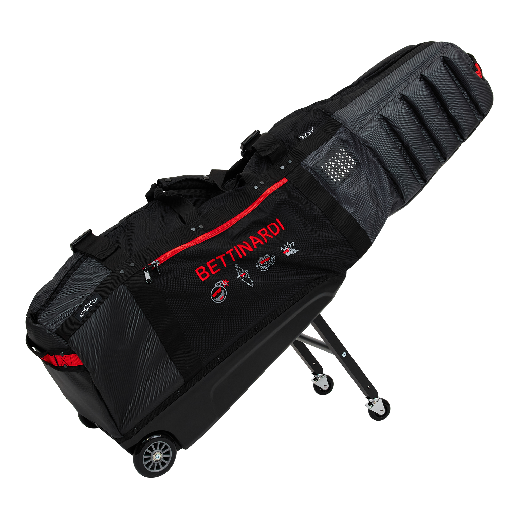 Black golf travel bag with red zipper and wheels, decorated with embroidered faces and text, on a stand.