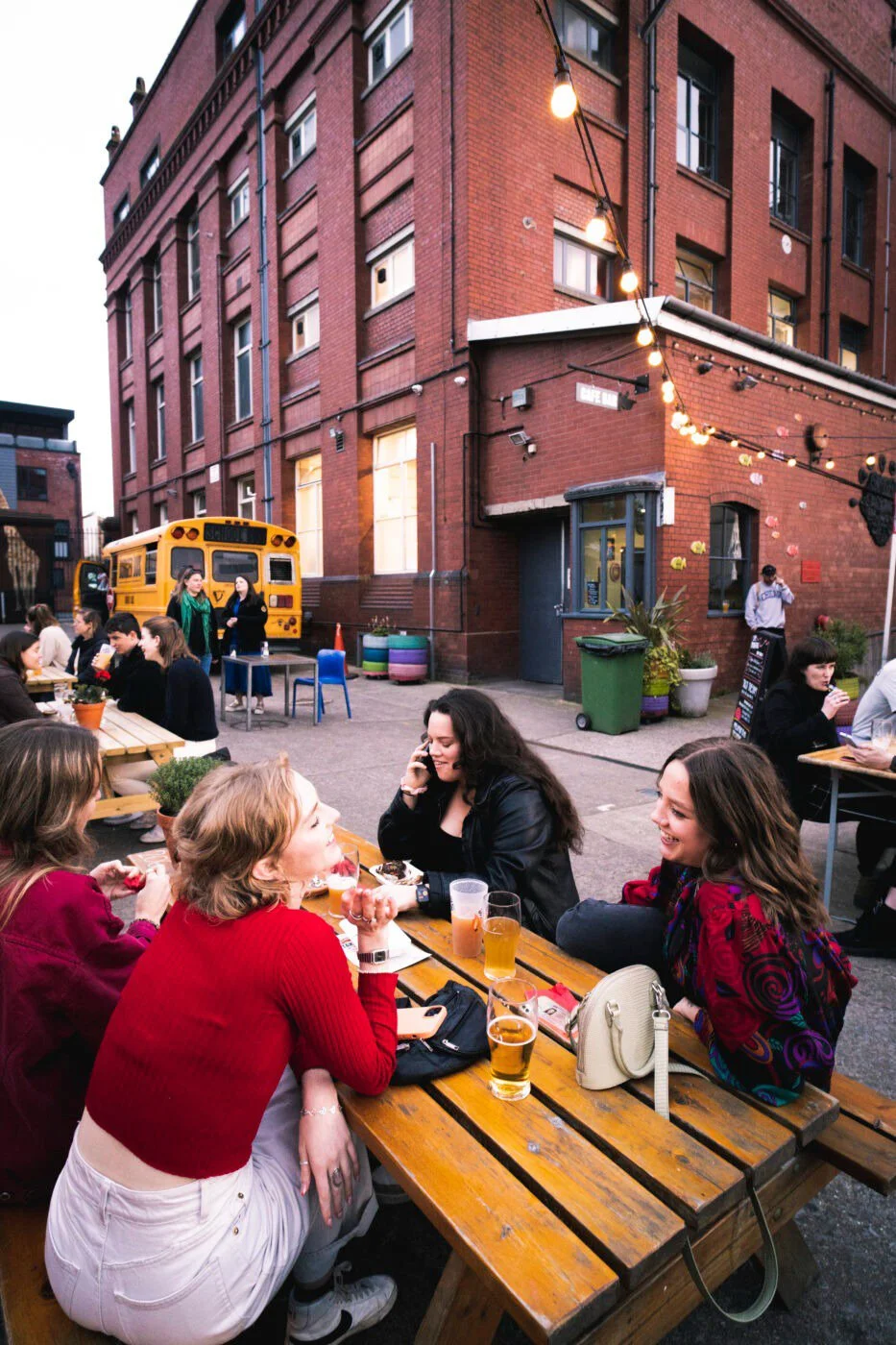 People sitting at outdoor table at the Tobacco Factory 