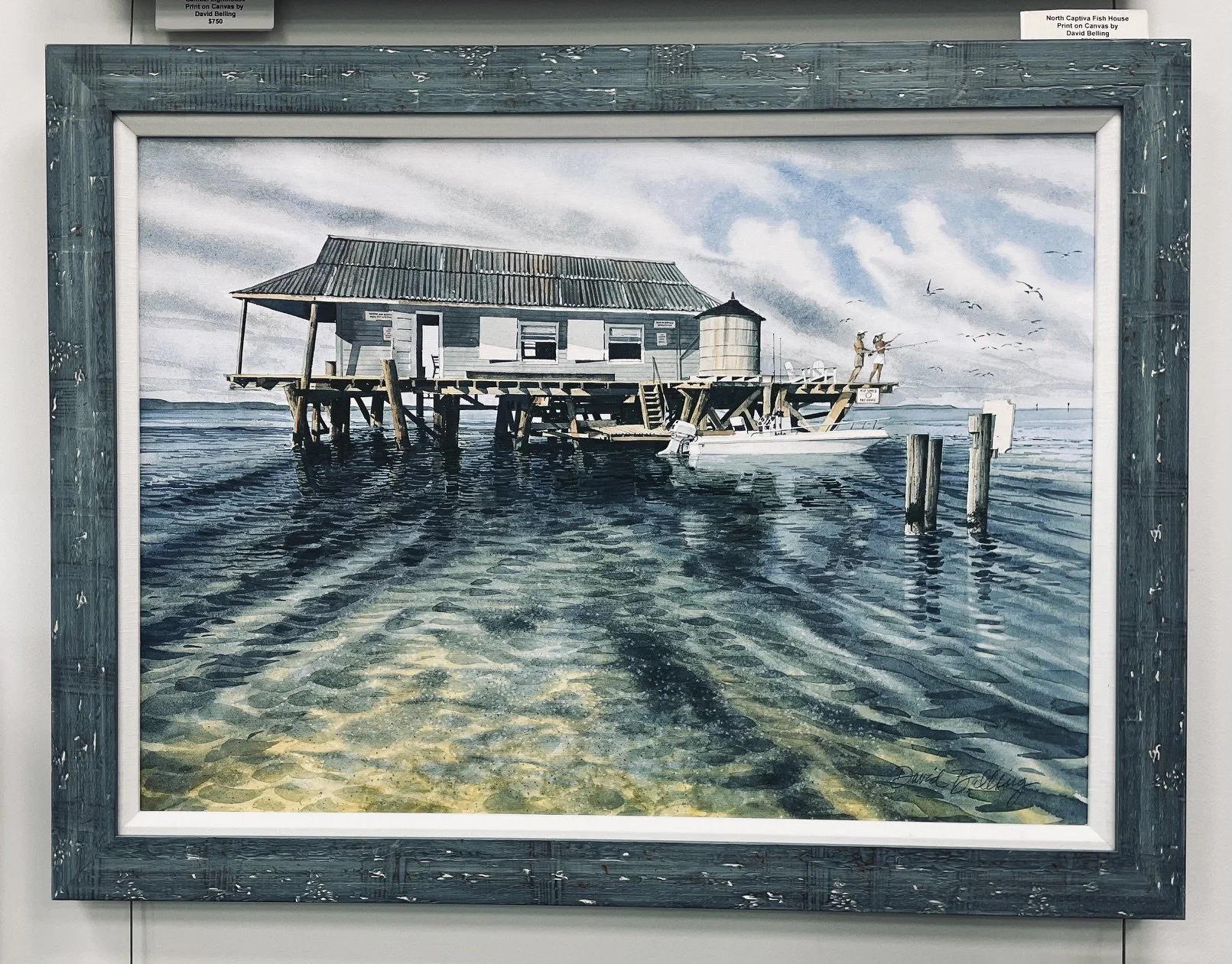 A watercolor painting of a house on stilts over the water with two people fishing on the dock, a boat tied to the dock, and seagulls flying in the sky.