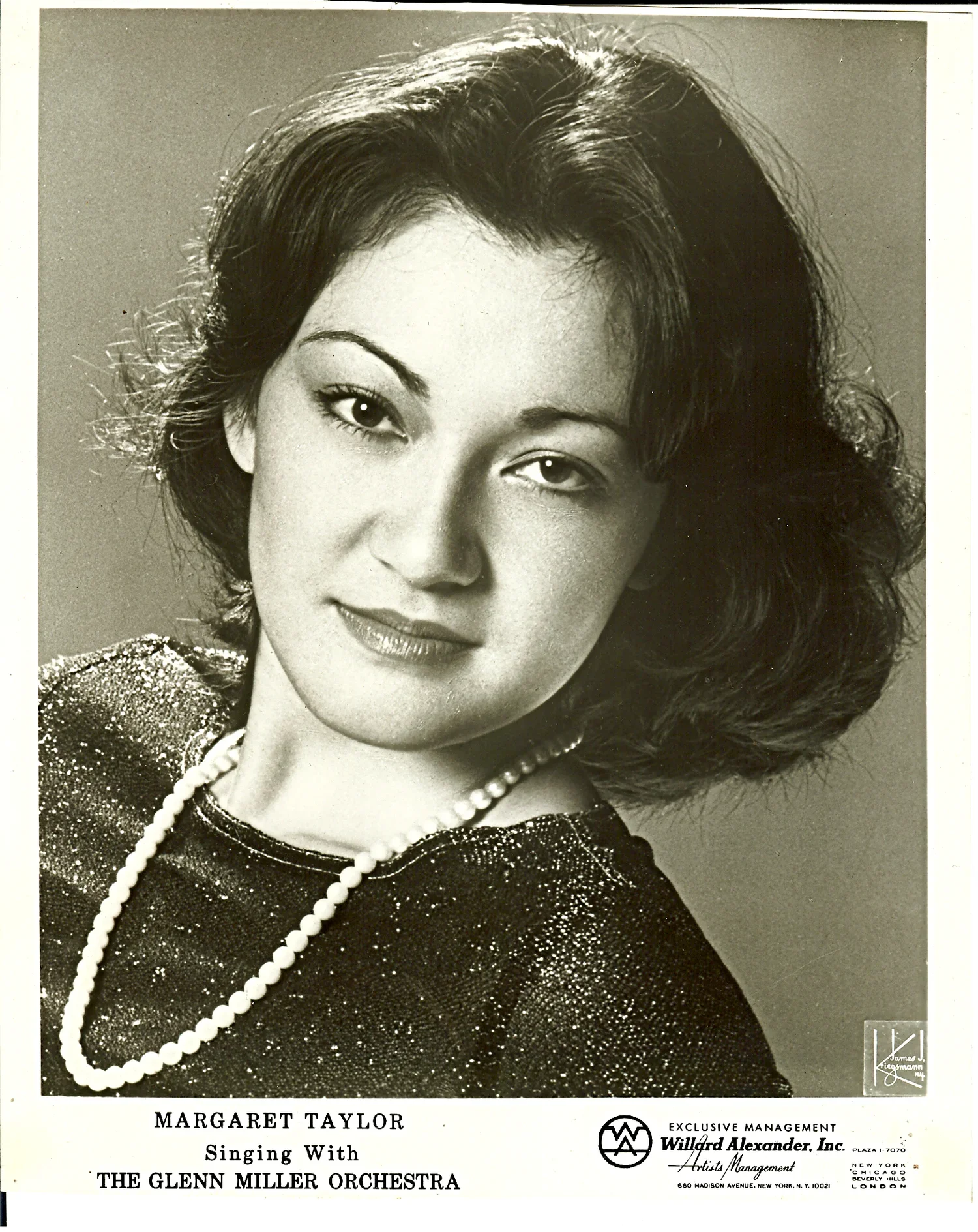 Black and white photograph of Margaret Taylor, a woman with dark hair styled in waves, wearing a dress with a sparkly fabric, a pearl necklace, and a confident expression. The image appears to be a promotional or promotional card for a singing perfor