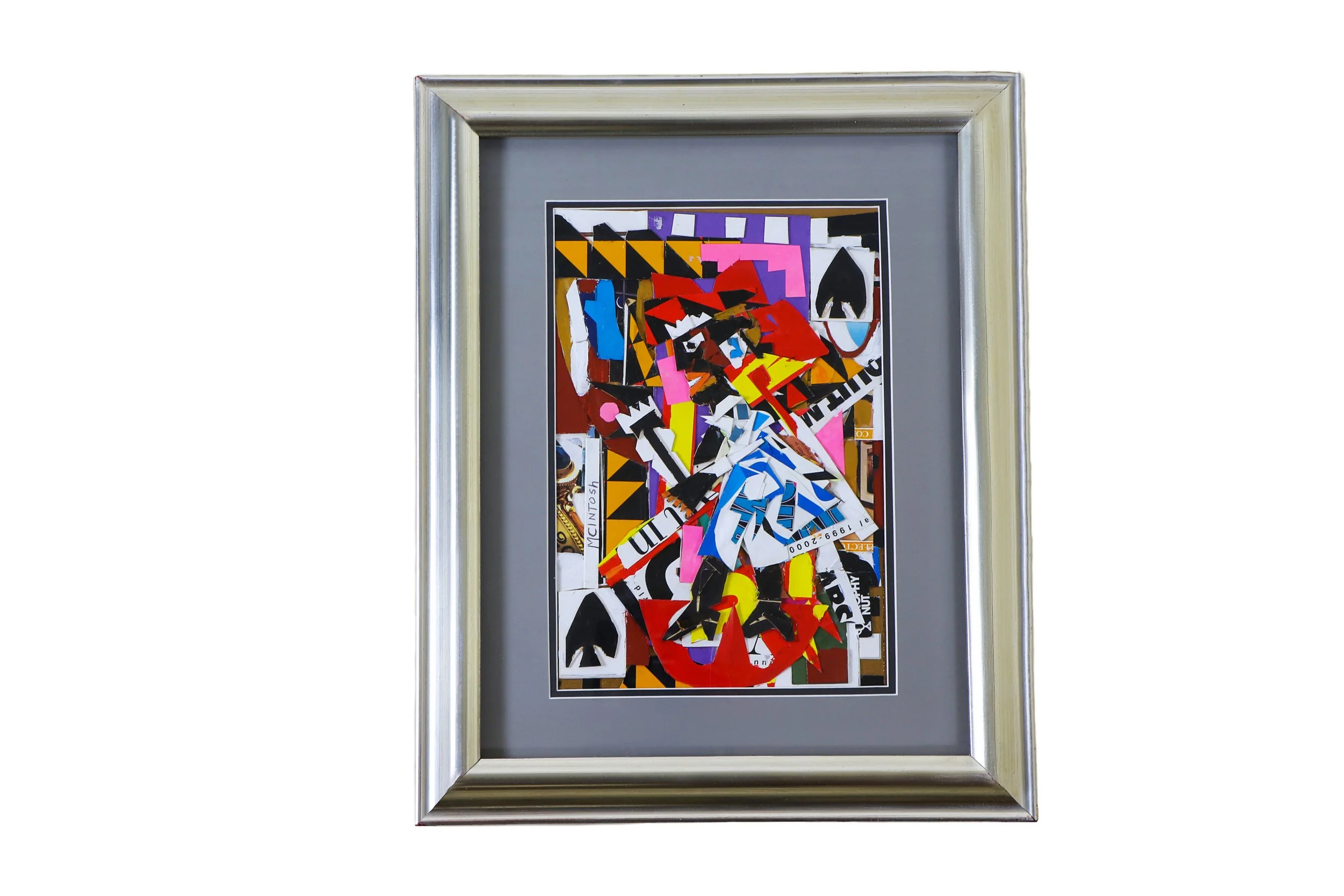 Mixed media collage artwork by Karl A. McIntosh featuring torn and layered magazine, newspaper, and advertising paper in a silver frame.