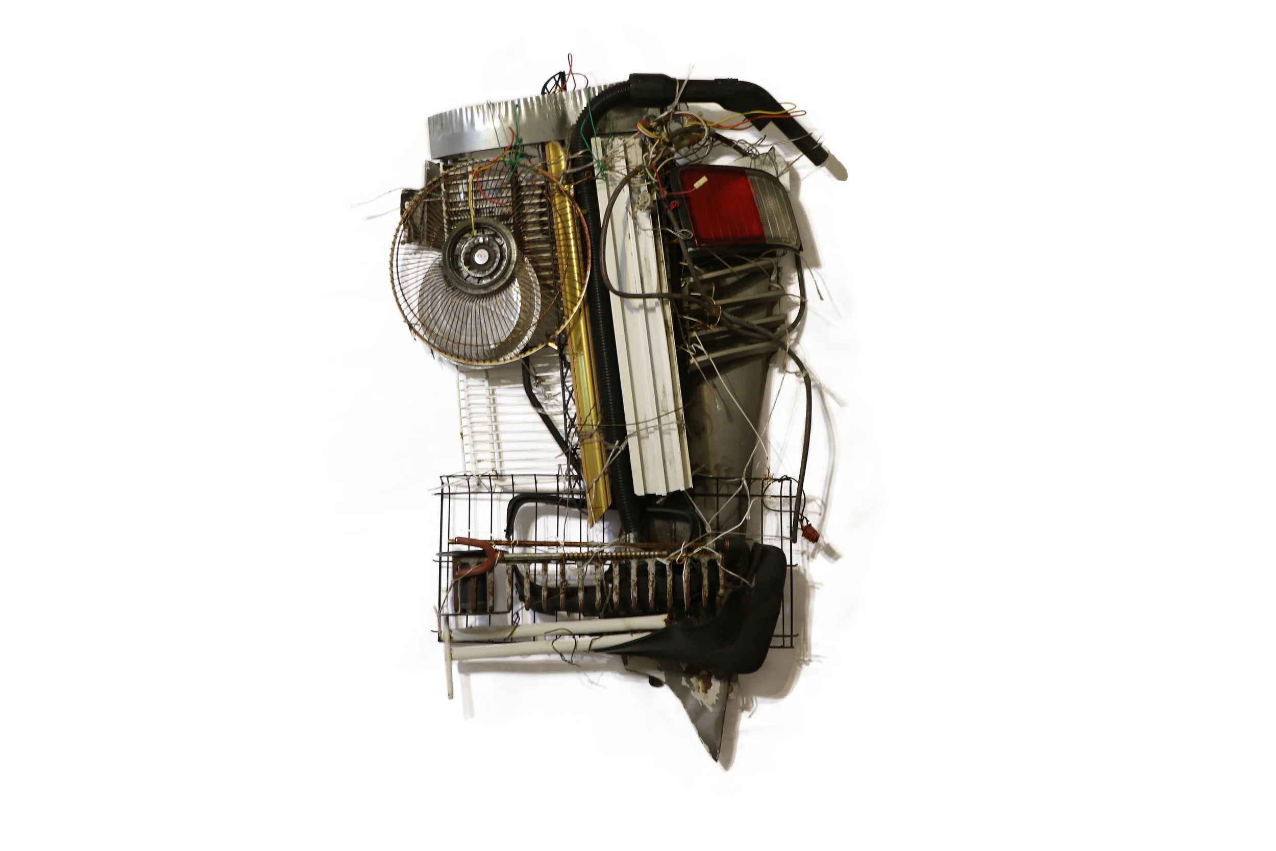 Found object artwork by Karl A. McIntosh featuring salvaged electronic components, circuit boards, wires, and mechanical parts assembled into an abstract mixed-media composition.