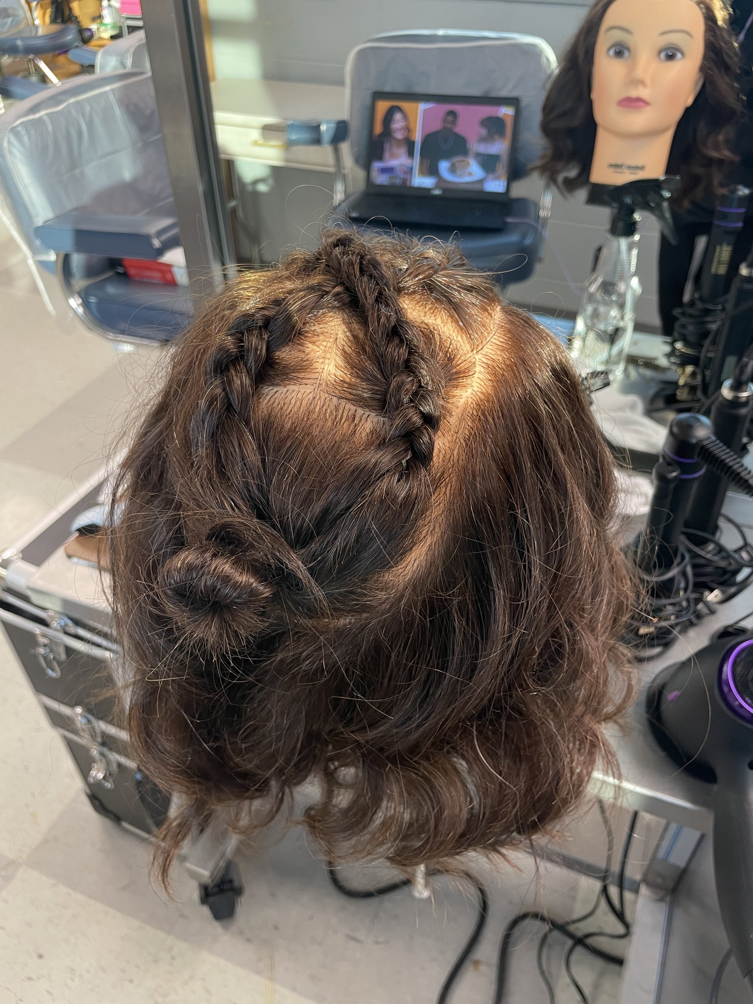 Criss cross braids into a bun with curls