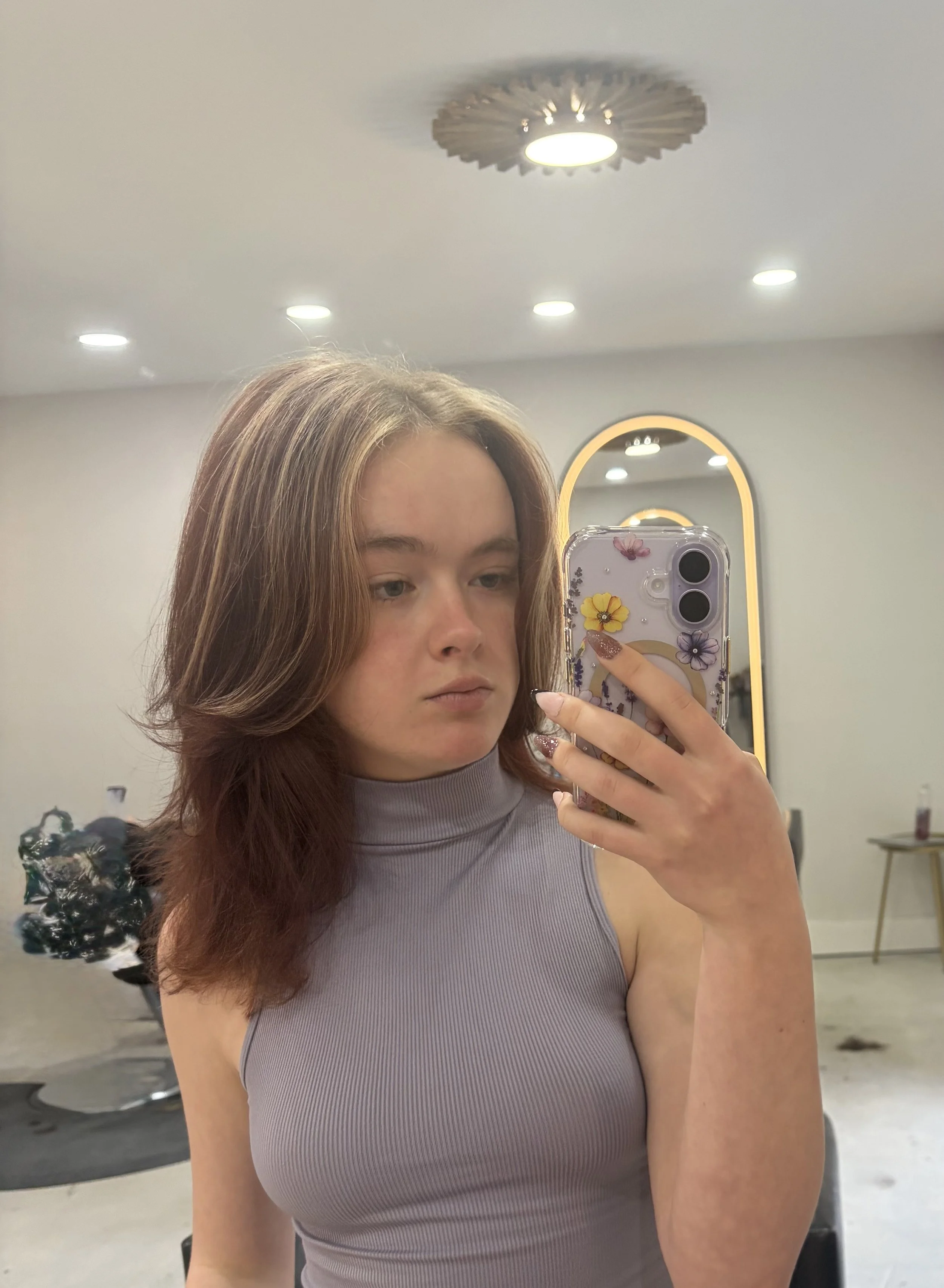 Woman's cut with lots of layers and curtain bangs