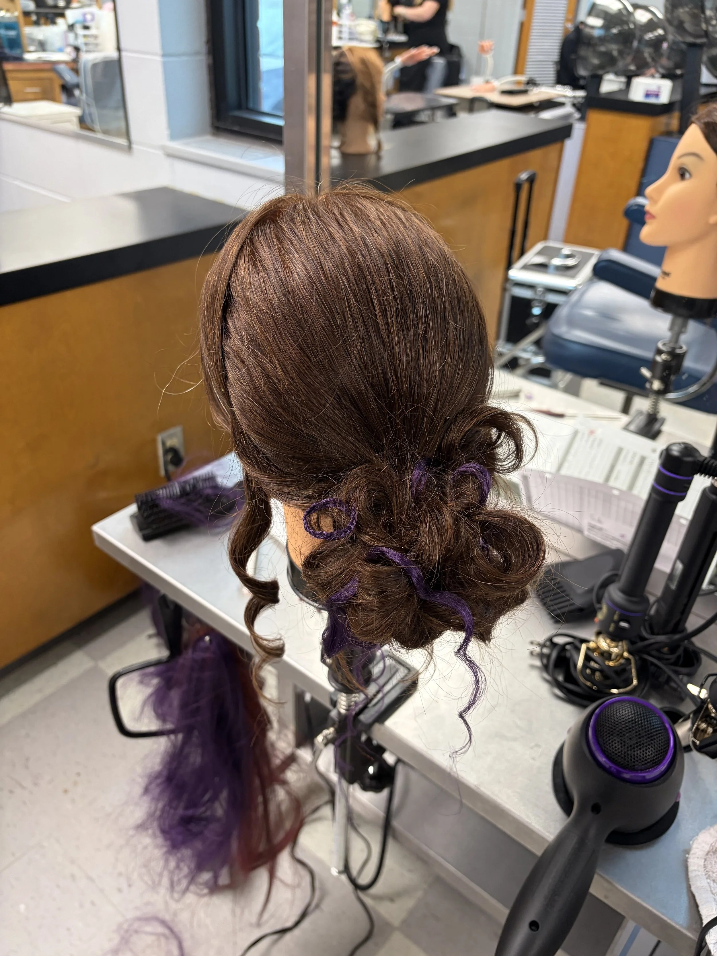 Slick back bun with add in purple hair braids