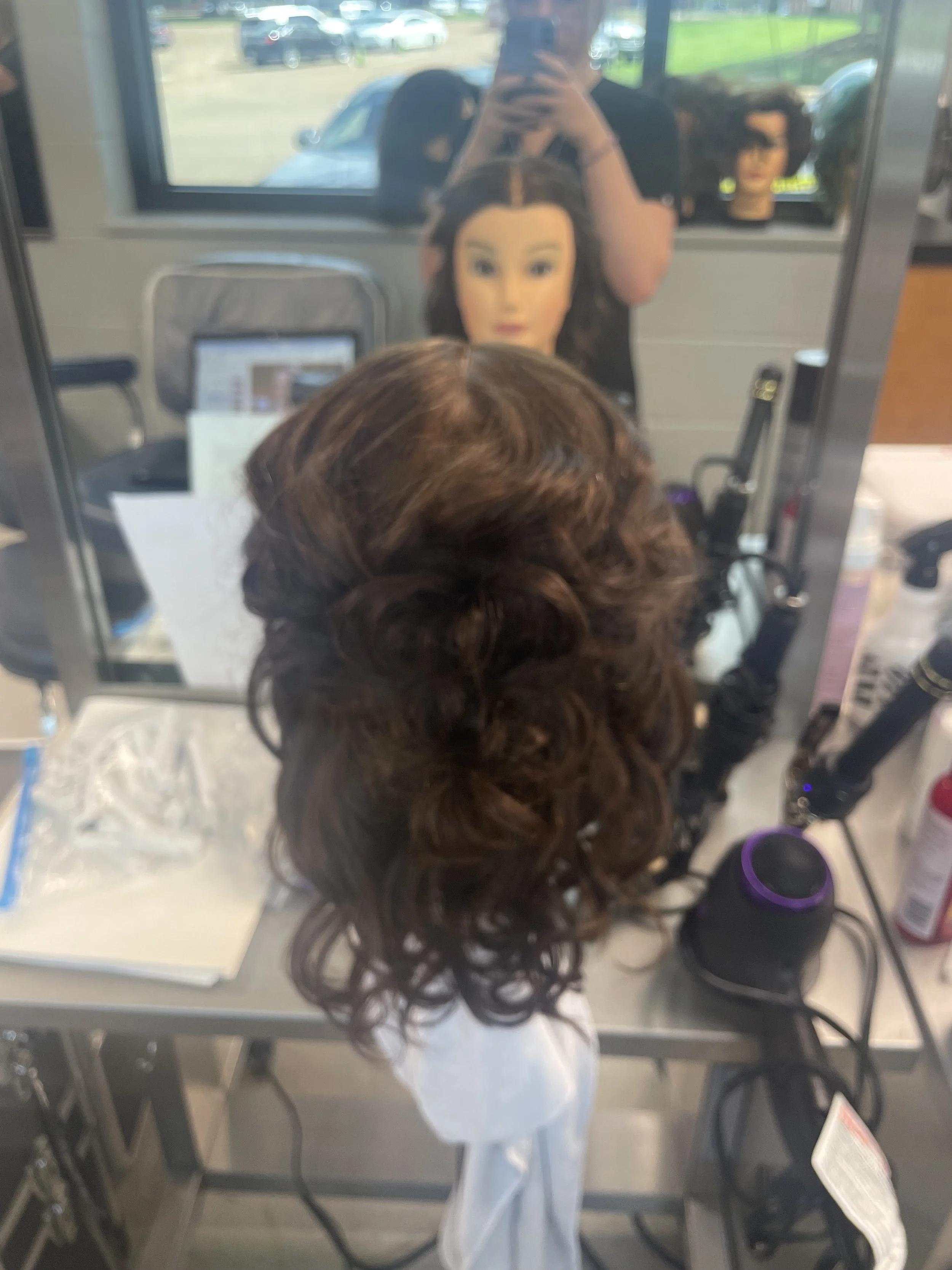 Half up half down with side fishtail braids into a bun and curls