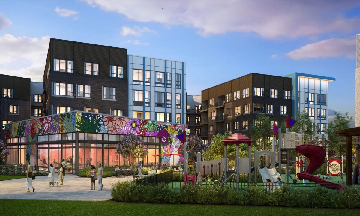 Modern apartment complex with colorful mural, playground, and walking people in a park setting.
