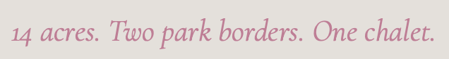 Text reading '14 acres. Two park borders. One chalet.' in pink cursive font.