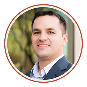 A headshot of Daniel Zirakzadeh, Founder and CEO of AltoRoc Partners consulting firm with greenery in the background.