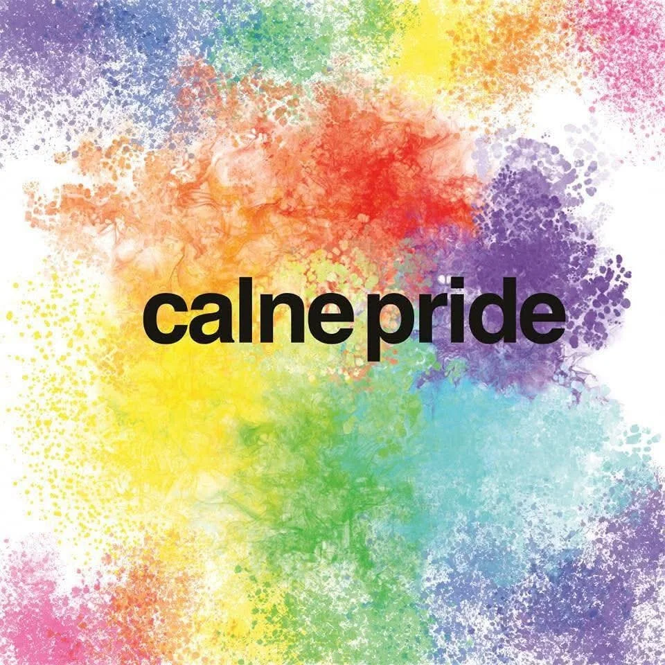 Colorful splashes of paint in rainbow colors with the words "calne pride" in bold black letters in the center.