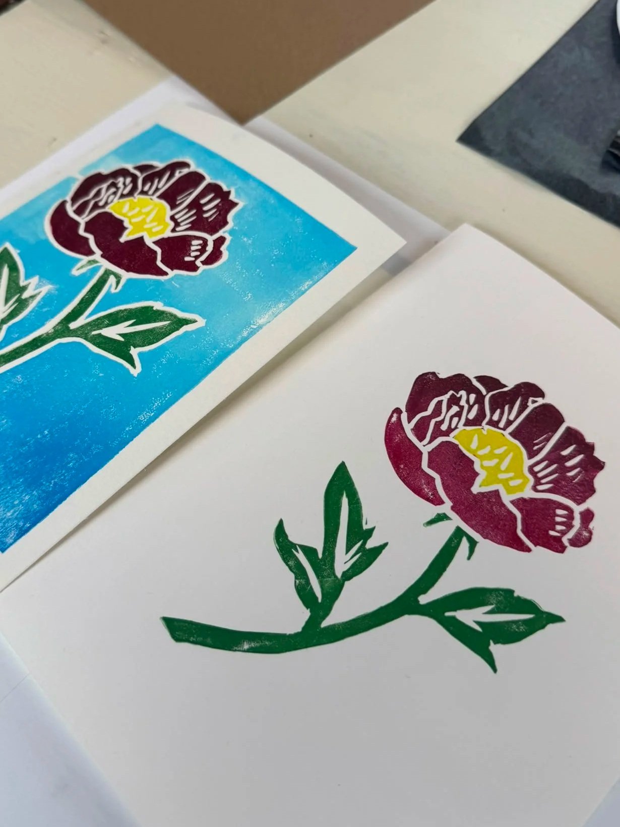 Colorful sticker of a maroon peony flower with green stem and leaves, and a yellow center, on a white background.