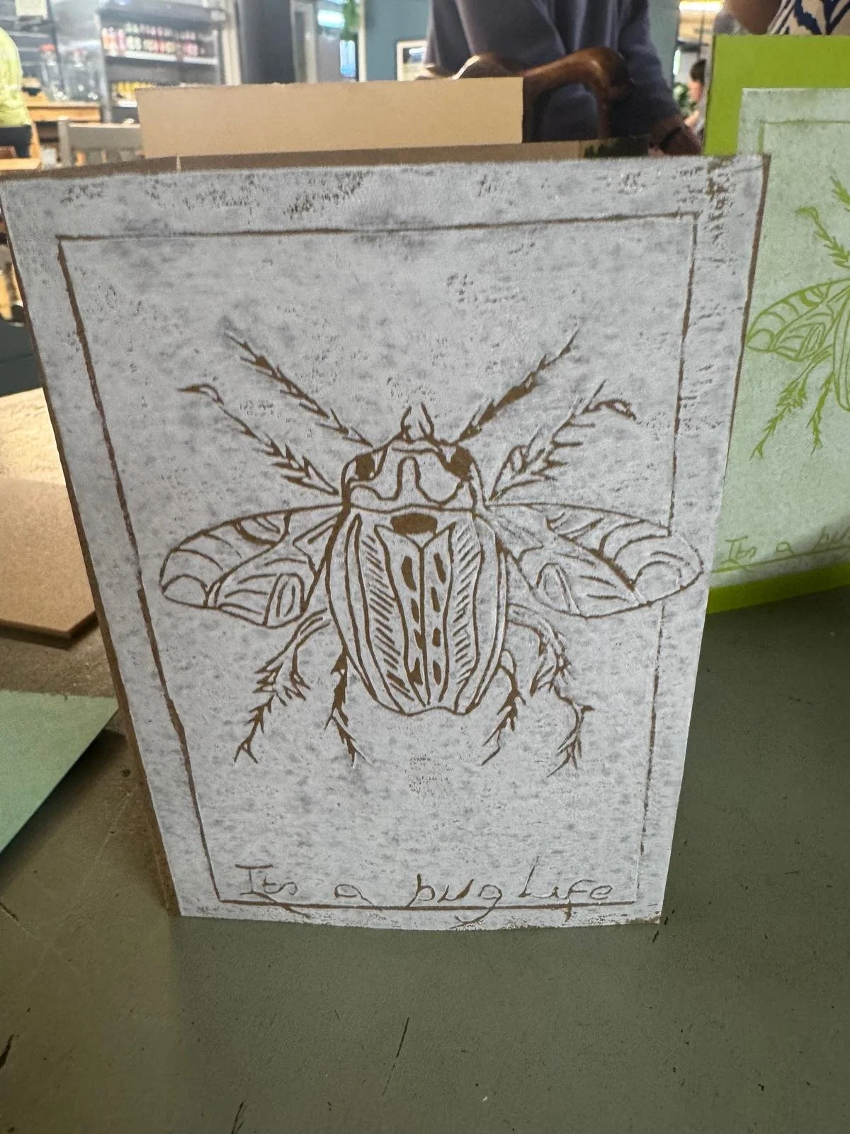 Hand-drawn illustration of a beetle on a textured background, with the phrase "It's a big Lucy" written beneath it.
