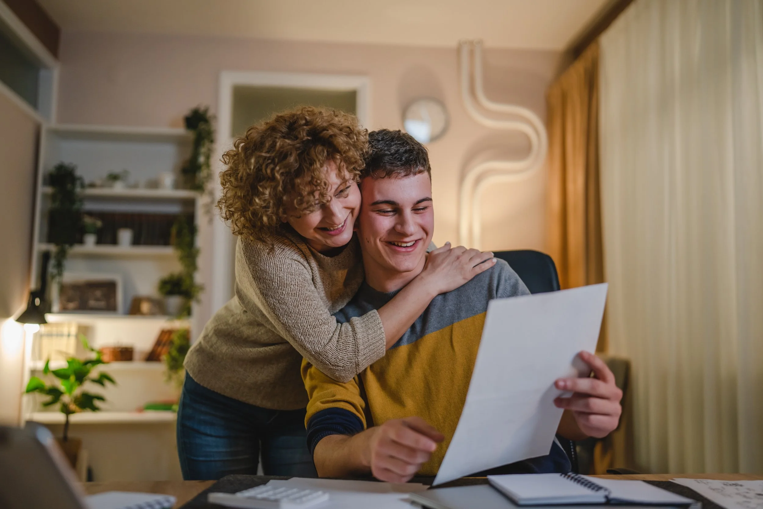 Boy and mom looking at scholarship recieved