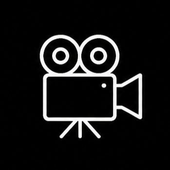 Simple white icon of a video camera with two large reels on top, set against a black background.