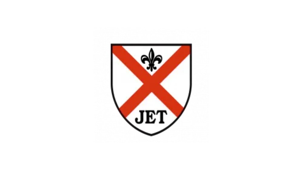 A crest with a red diagonal cross, a black fleur-de-lis symbol at the top, and the word "JET" at the bottom, on a white background.