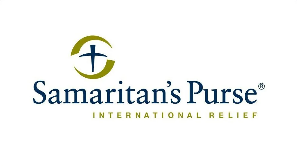 Logo of Samaritan's Purse, a Christian humanitarian aid organization, featuring a cross inside a stylized circle and the text 'Samaritan's Purse' with the subtitle 'International Relief'.