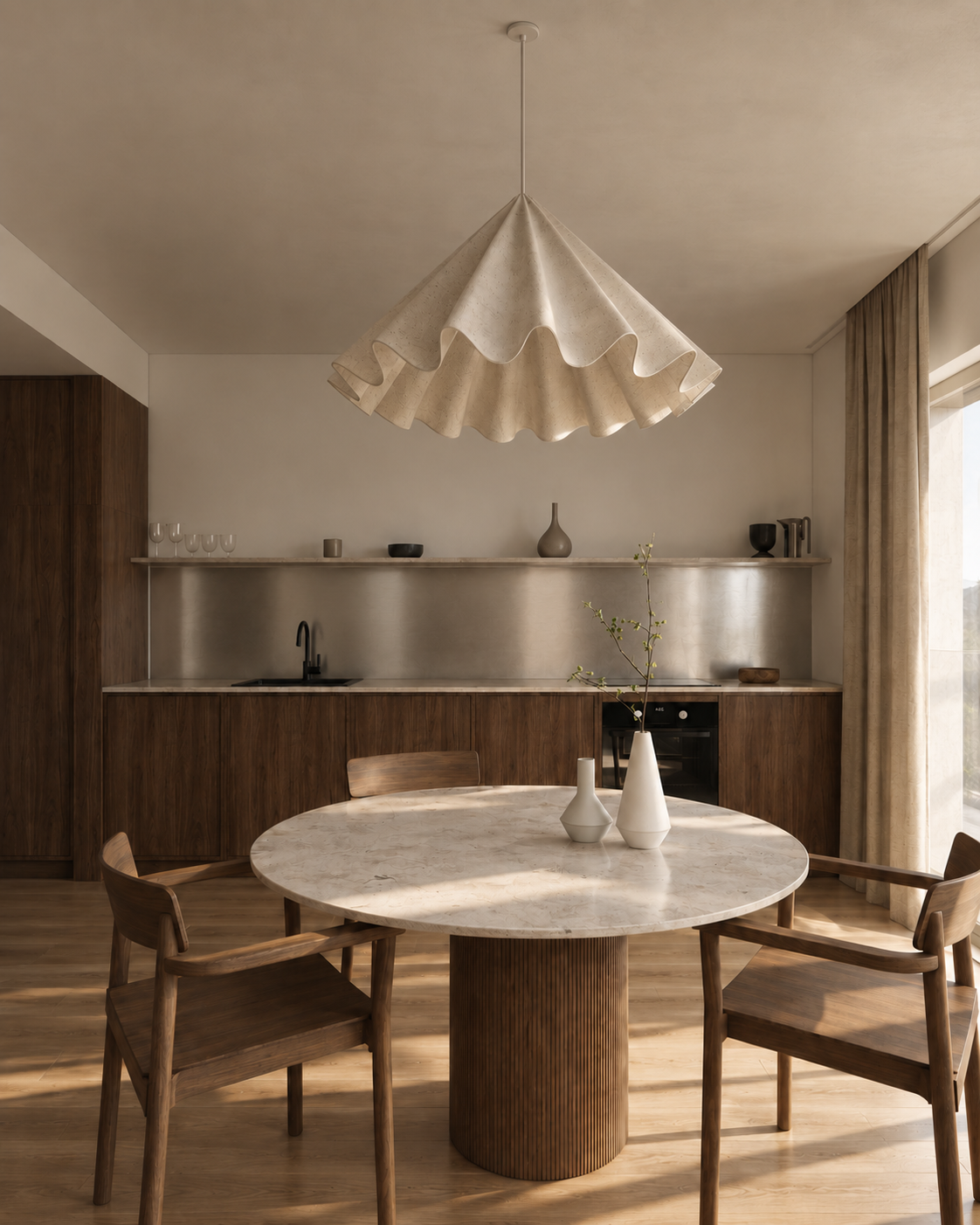 Minimalist kitchen and dining area with wooden furniture, a marble round table, and a large beige pendant light.