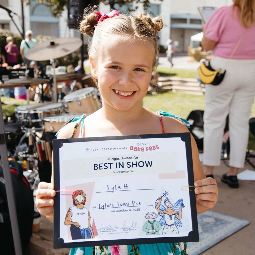 Best in show winner Lyla holding up award certificate