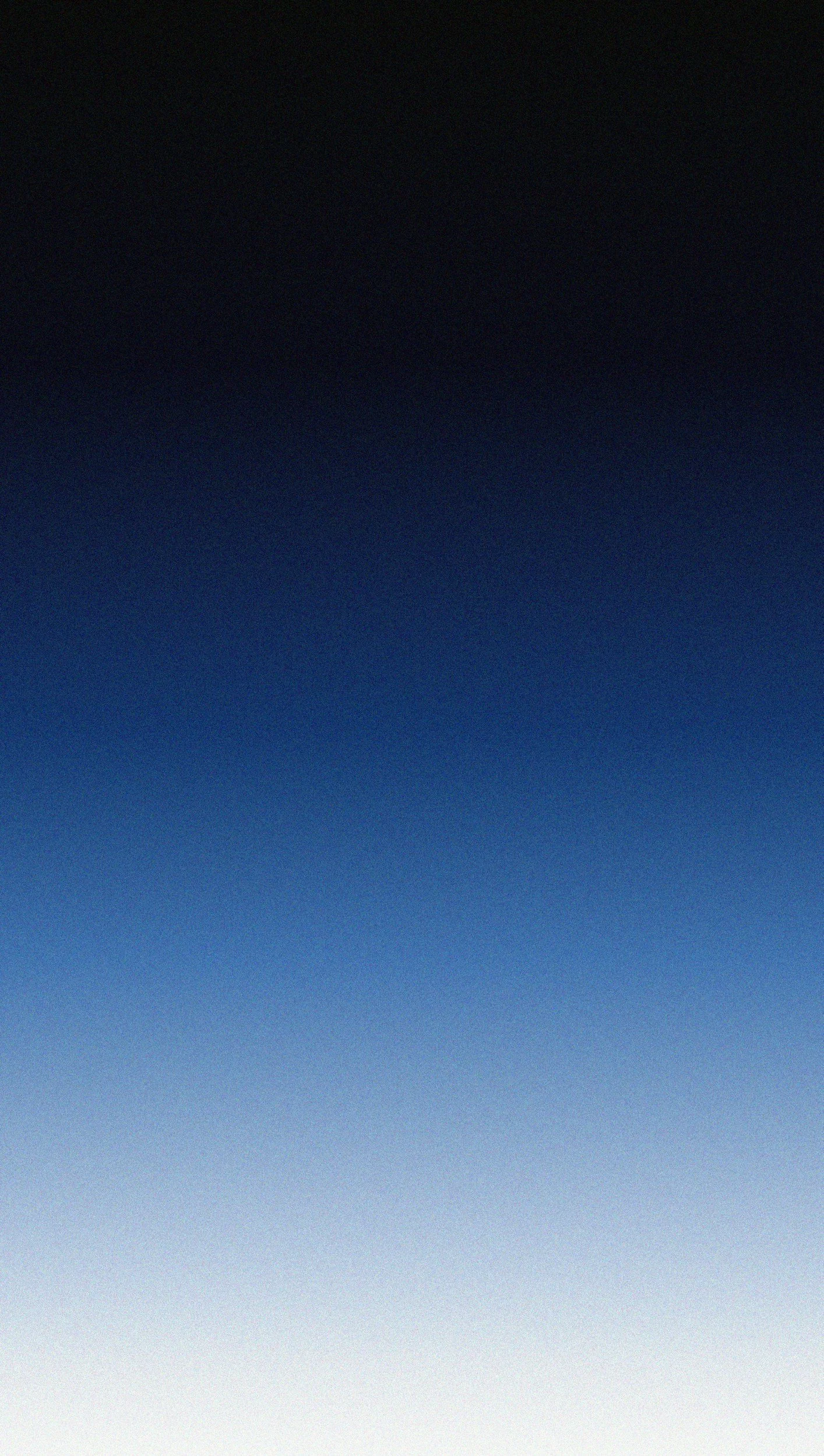 Gradual transition of sky from dark navy at the top to light blue at the bottom, with no visible objects or scenery.