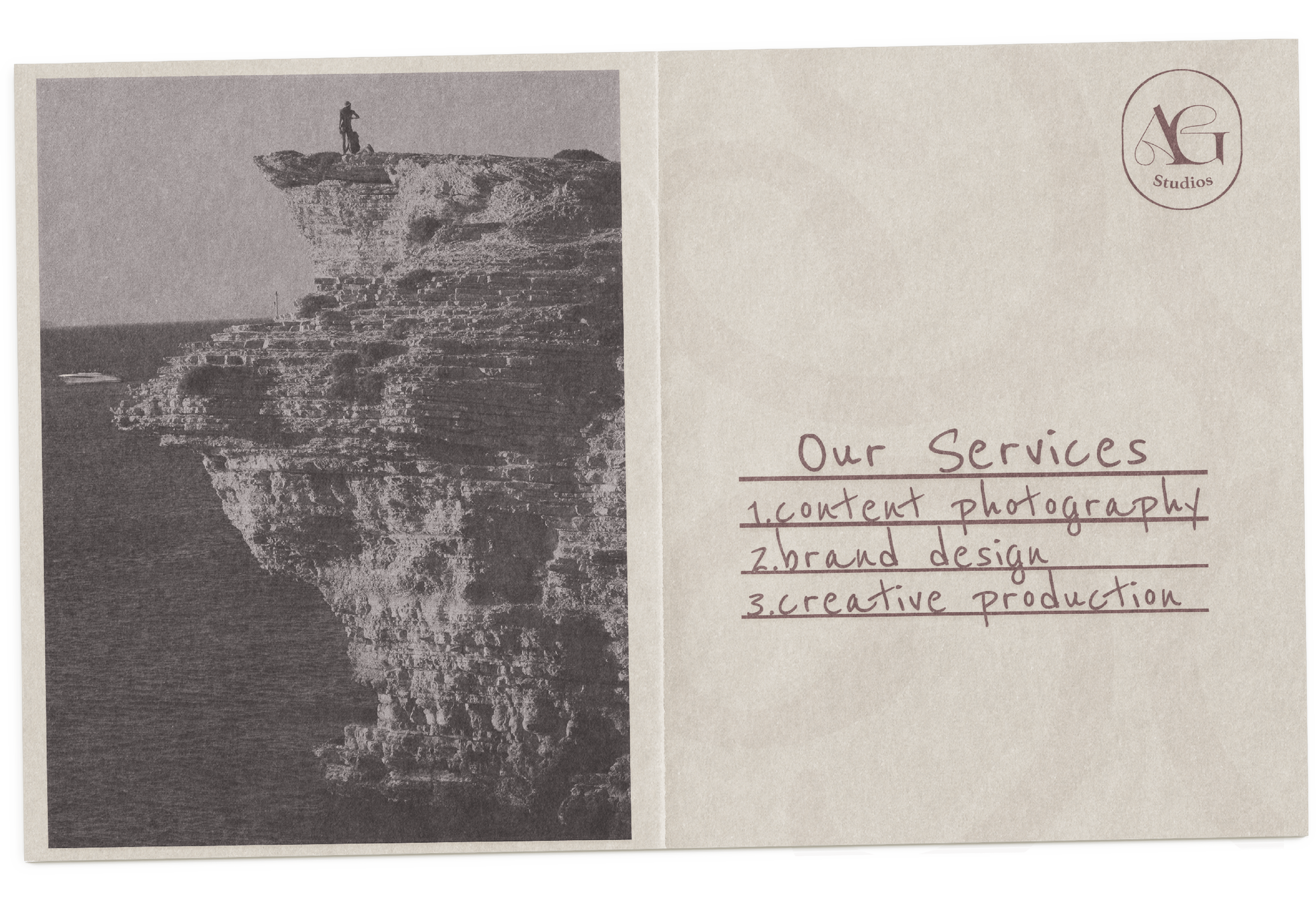 A vintage-style promotional card features a black and white photo of a person standing on a rocky cliff overlooking the sea, with the company's logo and list of services on the right side, including content photography, brand design, and creative production.