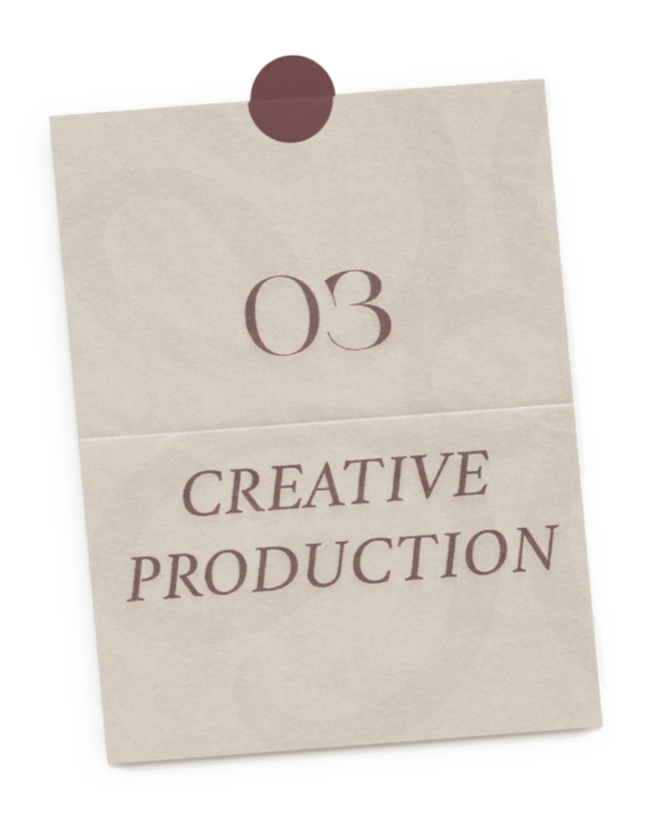 A beige note card with a brown magnetic clip at the top, displaying the text '03 CREATIVE PRODUCTION' in purple.