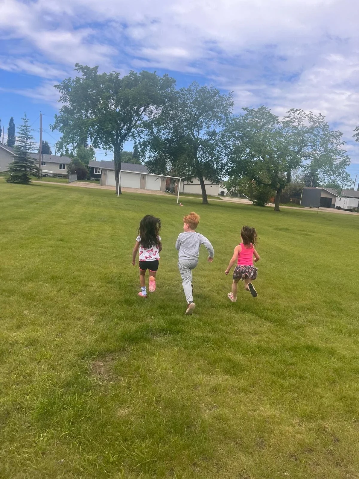 Encouraging friendship building with a fun run in a grassy area.