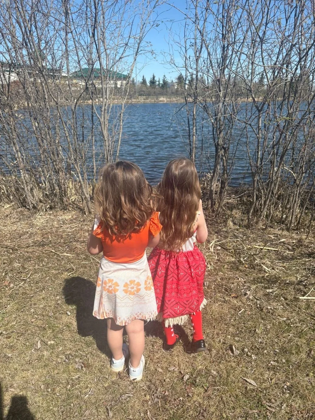 Two young children exploring their community outdoors.