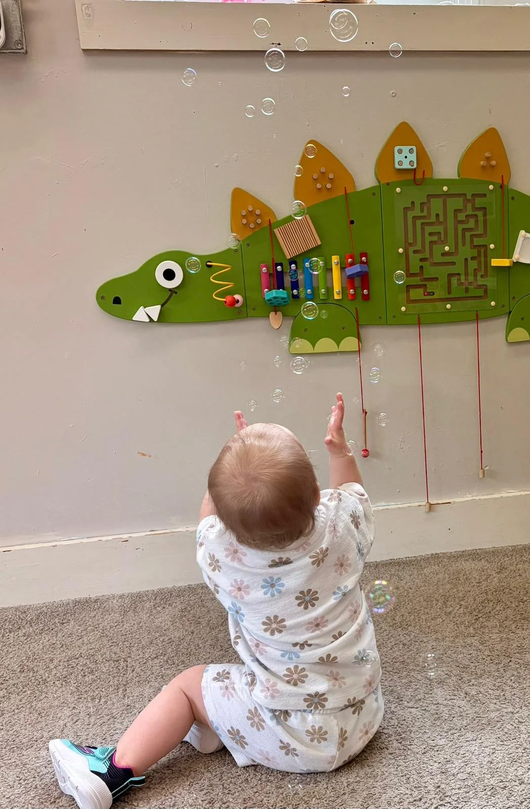 An infant playing with bubbles
