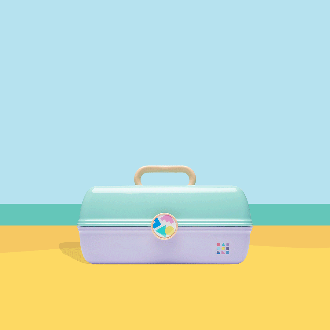 Colorful toy carrying case on a yellow surface with pastel background.