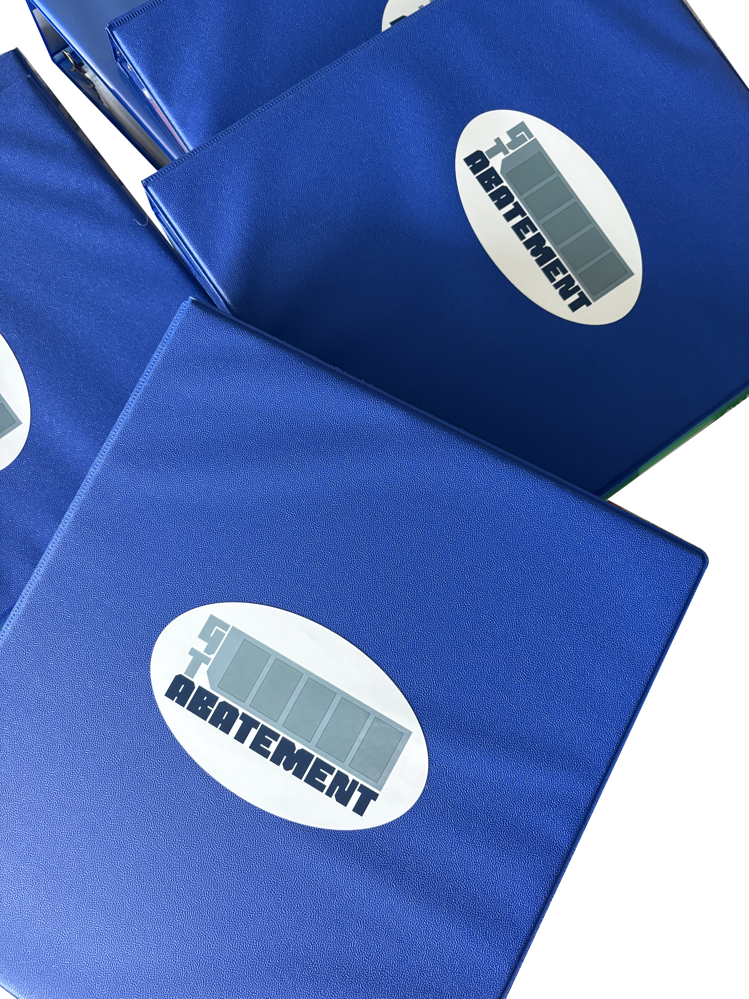 Close-up of blue folders or binders with a label that reads 'GT Abatement' and a digital icon, arranged in a stack.
