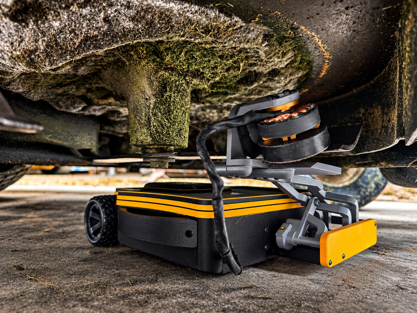 Robotic Mower Beneath Grassy Deck.png