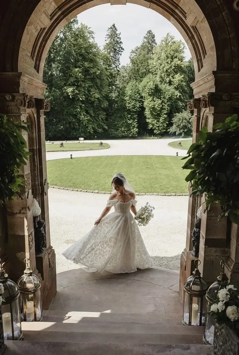 bride-twirling-archway-castle-leslie.webp