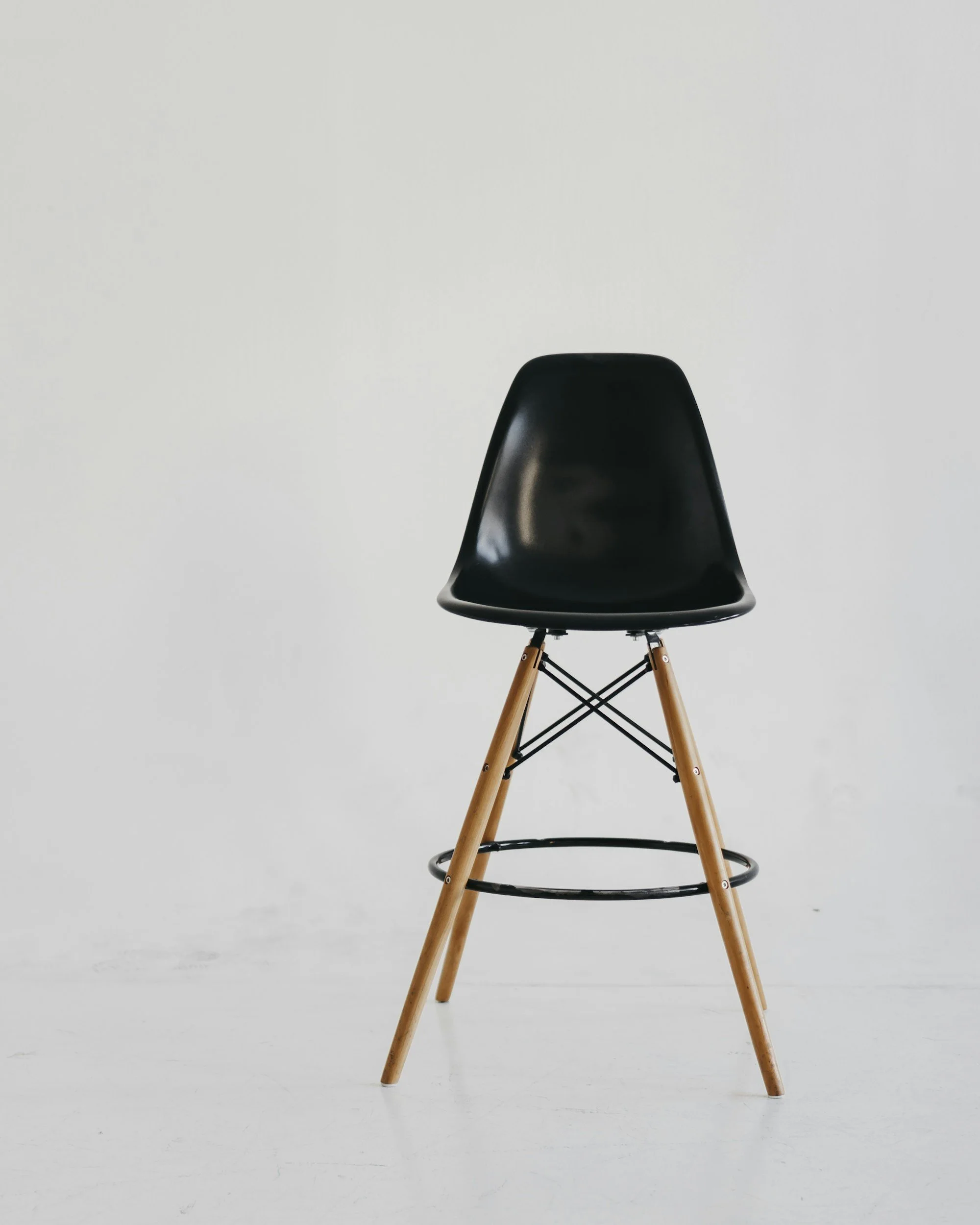 hard black stool on grey background