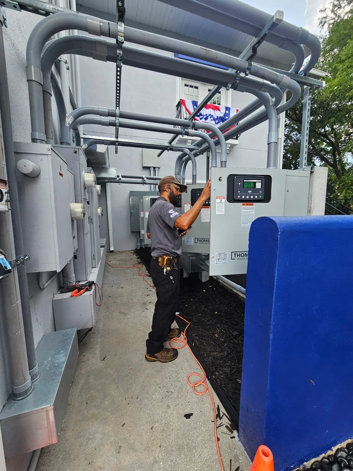 Technician inspecting large electrical or power system unit.