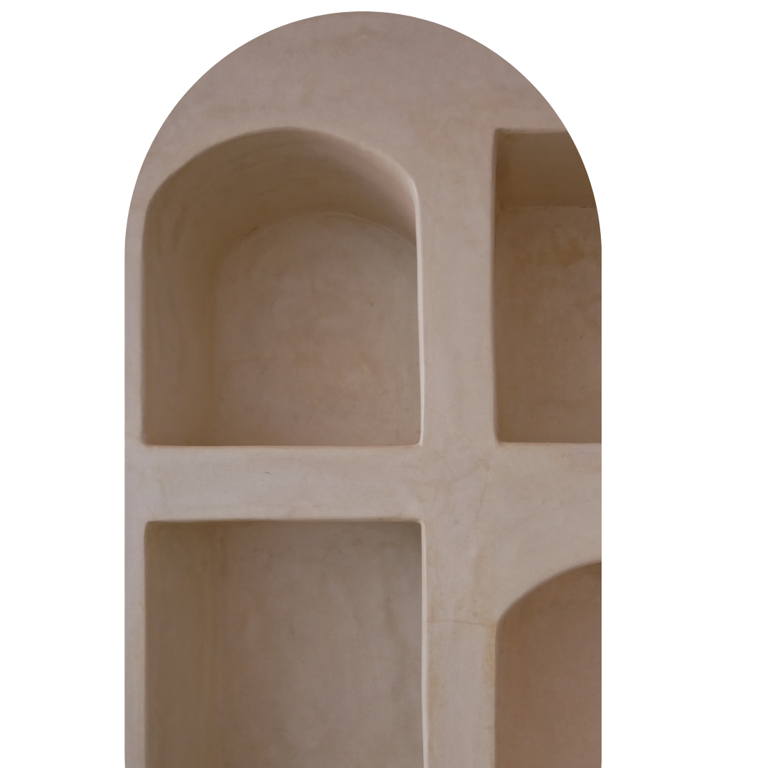 Close-up of a beige, four-compartment organizer or storage box with rounded and rectangular sections.