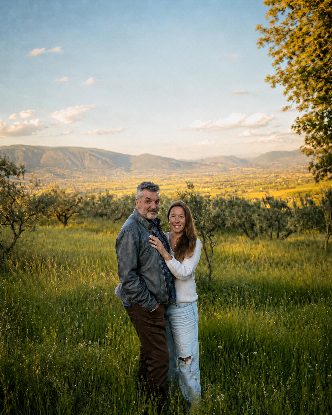 an image of Dave & Anna DeVries in a field with olive trees behind