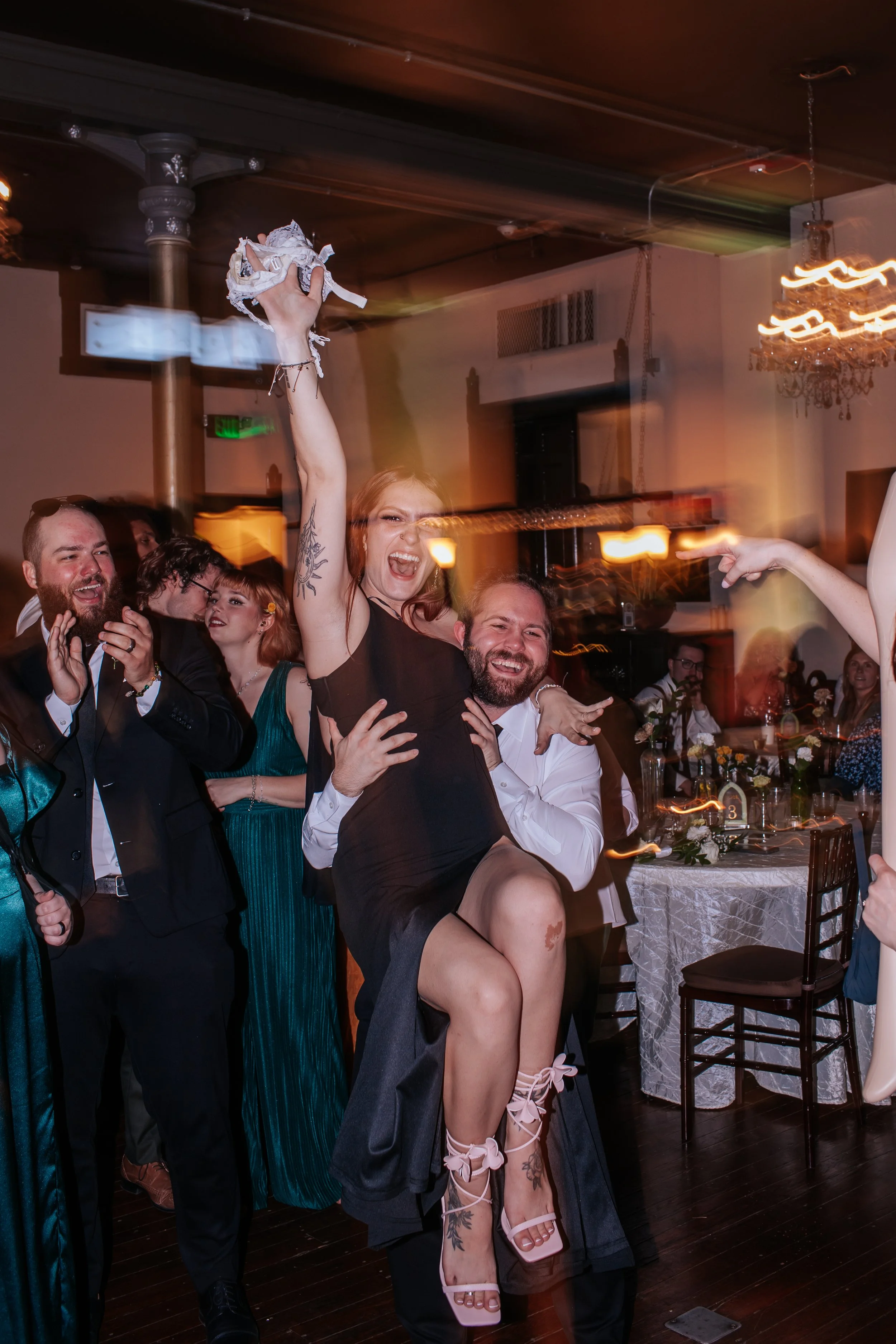 Myself and my fiancé celebrating at a wedding reception.