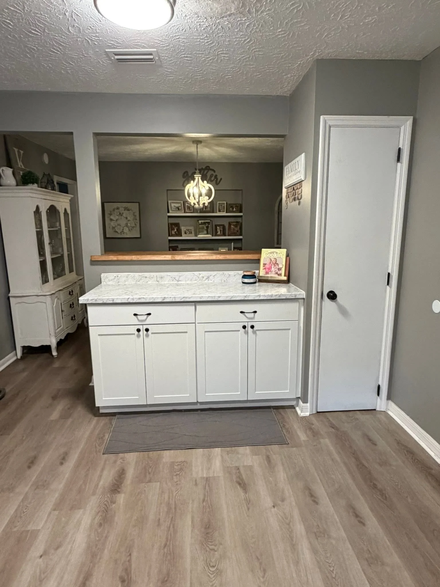 No pantry? No problem. 
This kitchen remodel was all about function meeting design. We created a custom pantry for much-needed storage and added a brand-new bar feature that completely changed the flow of the space. The bar is topped with warm butche