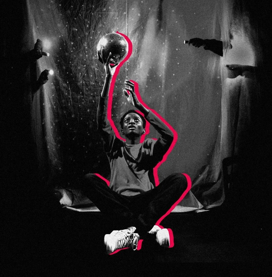 A black and white image of a young person crossed-legged, reaching up towards a sparkling disco ball.