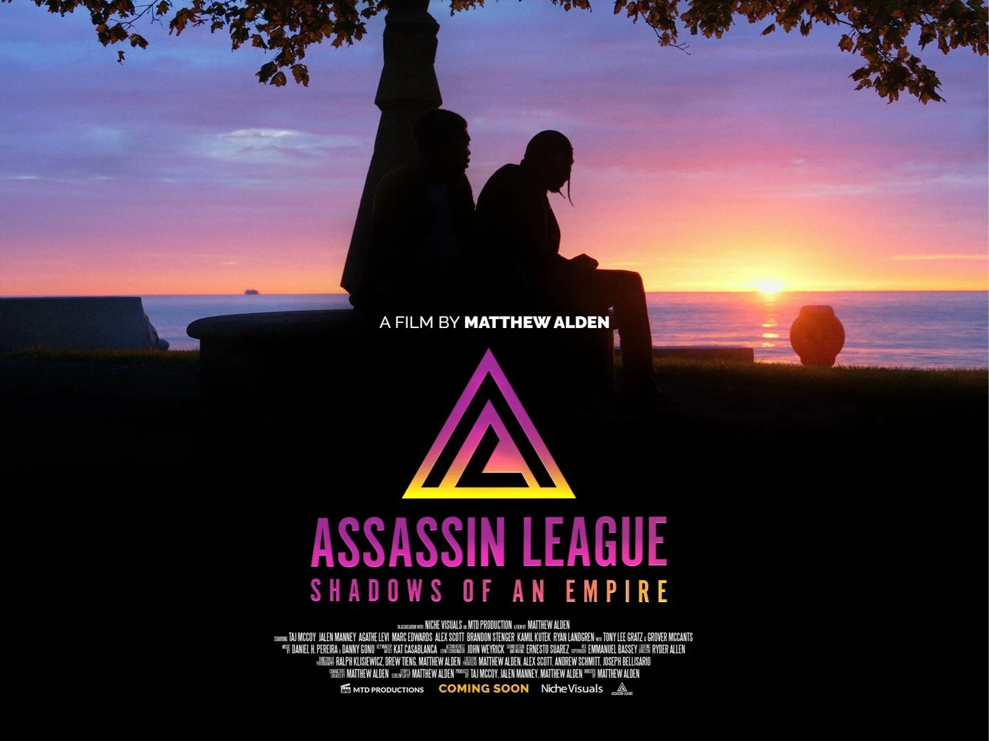 A promotional poster for the movie "Assassin League: Shadows of an Empire." The background features a silhouette of two people sitting under a tree with a sunset over the ocean. The title is prominently displayed in bold pink and purple text, with additional credits and information below.